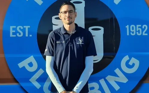 Kevin, Warranty Service Technician, in front of a Tucson Plumbing van