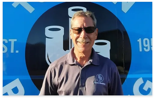 Ron, Service Manager, in front of a Tucson Plumbing van