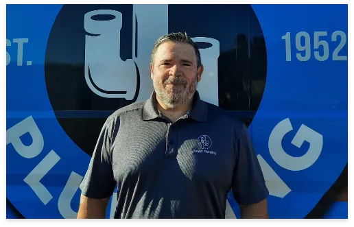 Tom, New Construction Warranty Technician, in front of a Tucson Plumbing van