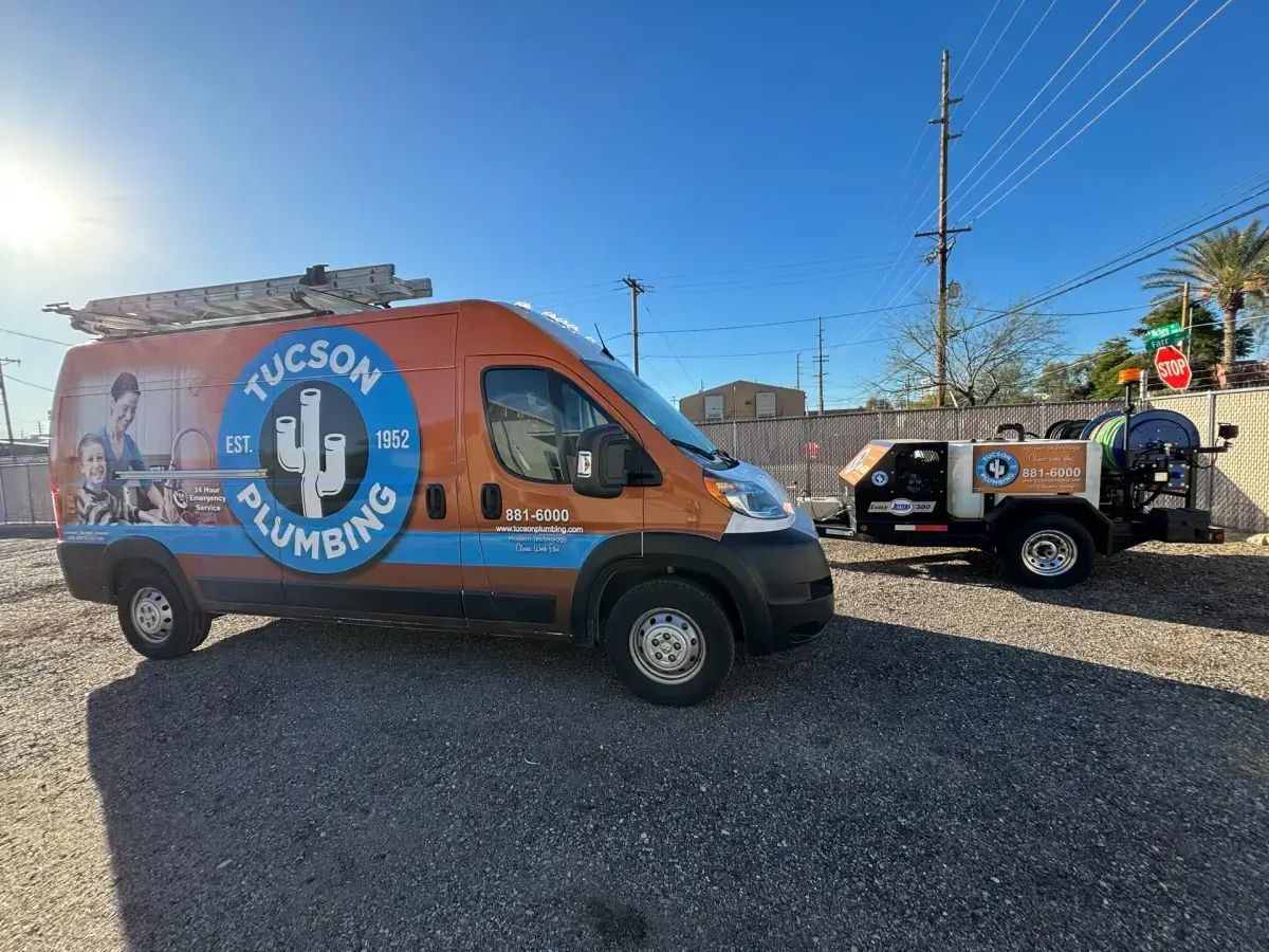 Tucson Plumbing van parked beside the company’s trailer-mounted hydrojetter